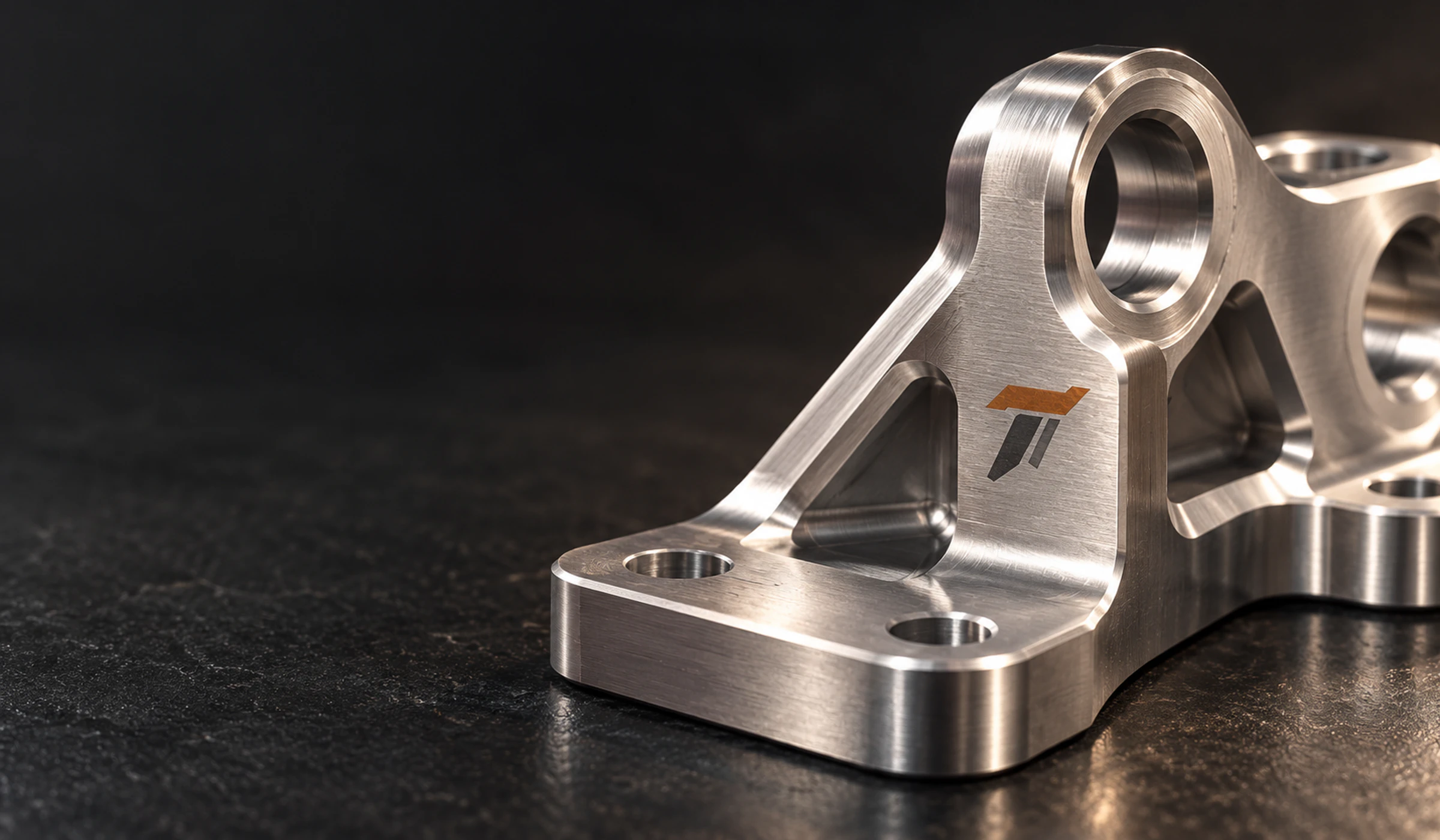 CNC-milled aerospace bracket with the Tenaxis mark